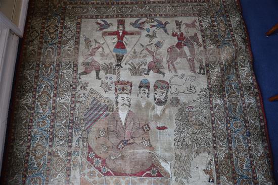 A 19th century Persian ivory ground pictorial rug, depicting a Shah, 6ft 9in by 4ft 7in.